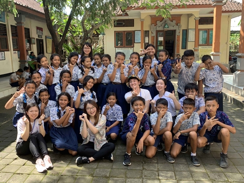 Service Trip in Bali - group photo with pupil